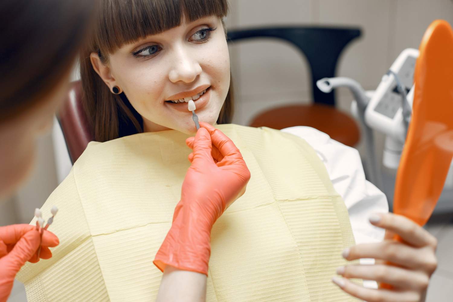 woman-in-dental-chair-girl-chooses-an-implant-beauty-treats-her-teeth