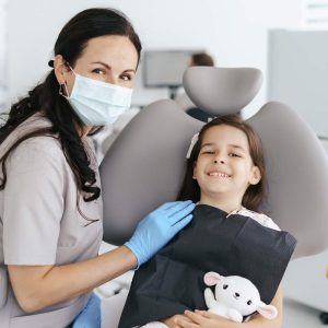 little-beautiful-girl-at-the-dentist-looking-and-smiling