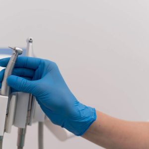 orthodontist-with-latex-glove-handling-dental-equipment